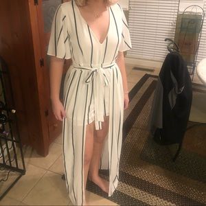 Off white romper with black stripes with a train